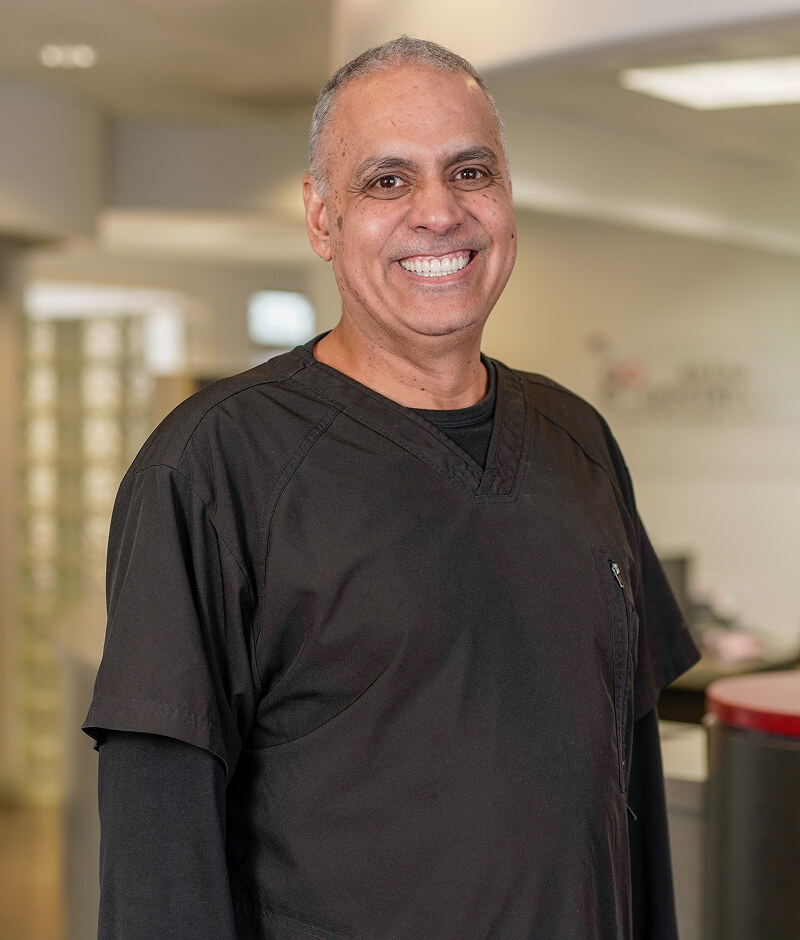 Dr. Navdeep Virk standing if the front office of Avenue Dental Group in Spokane Valley.